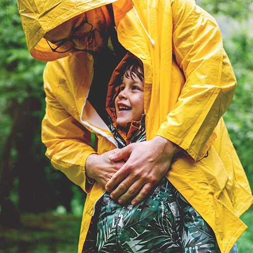 A father and son playing happily, knowing they have strong protection against identity theft.