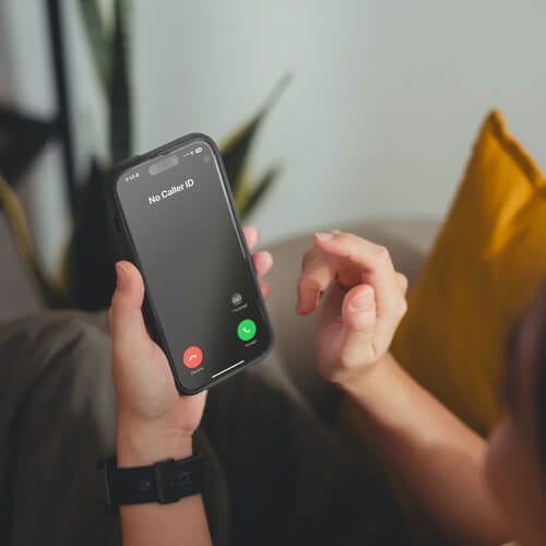 An image of a person looking at a call spoofing their own number.